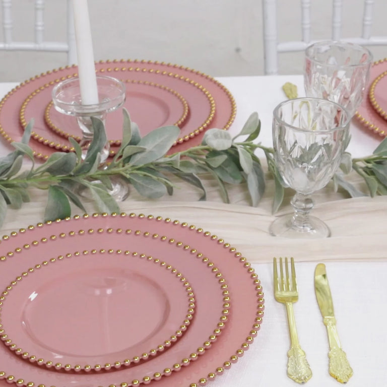 Dusty rose disposable dessert plates with gold beaded rim, perfect for parties.