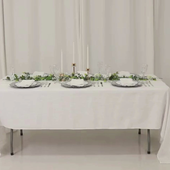 Silver acrylic charger plates with reef design on a white table setting.