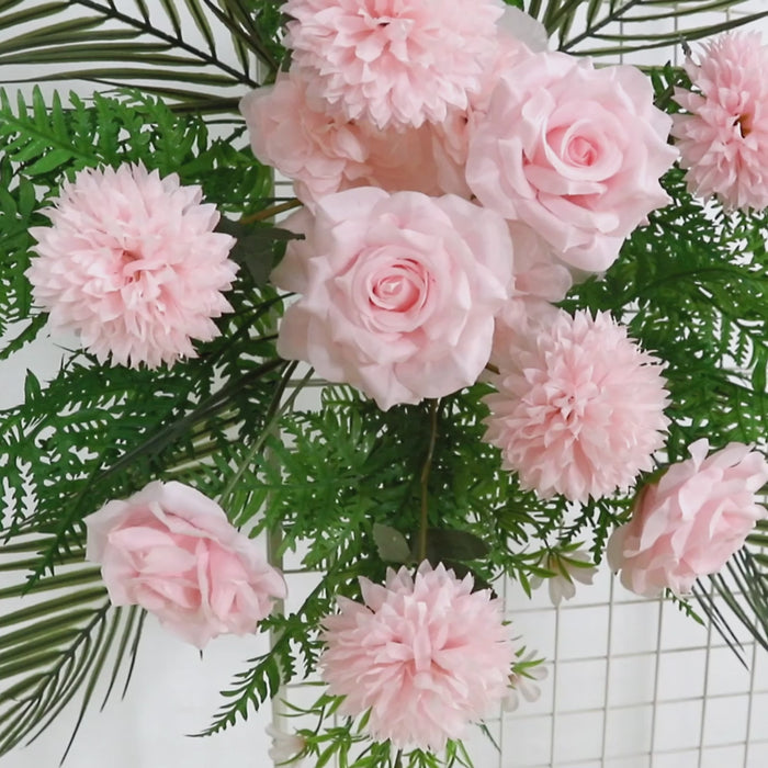 Blush rose and chrysanthemum floral swag with greenery and palm leaves.