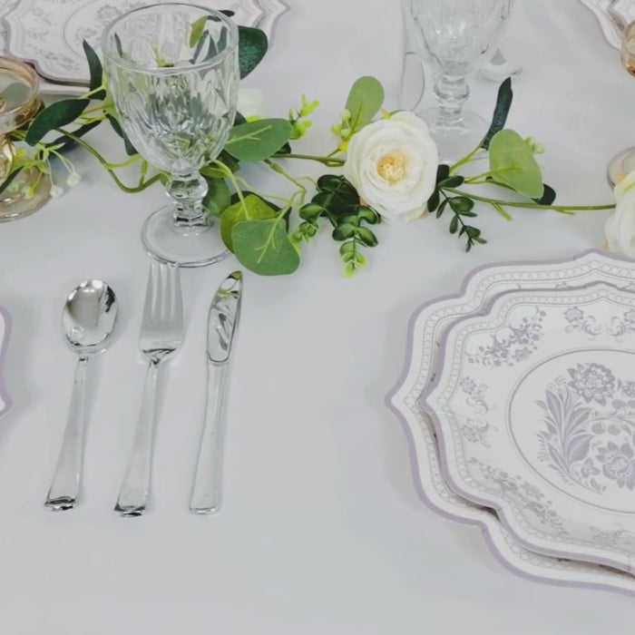 White paper dessert plates with lavender lilac damask floral print and scallop rim.