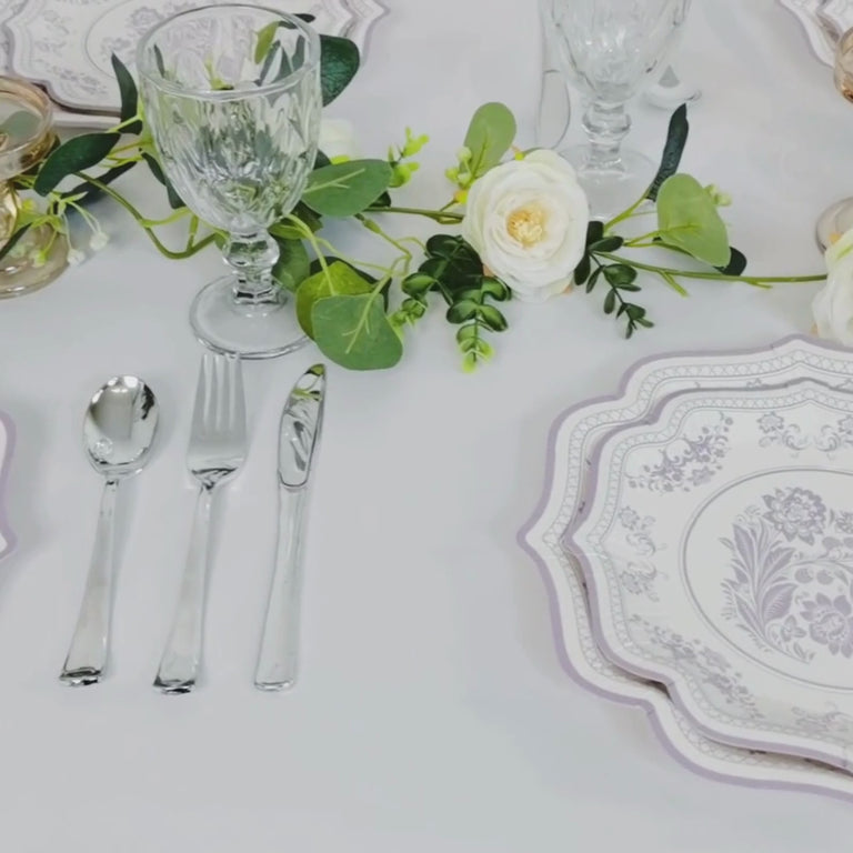 White paper dessert plates with lavender lilac damask floral print and scallop rim.