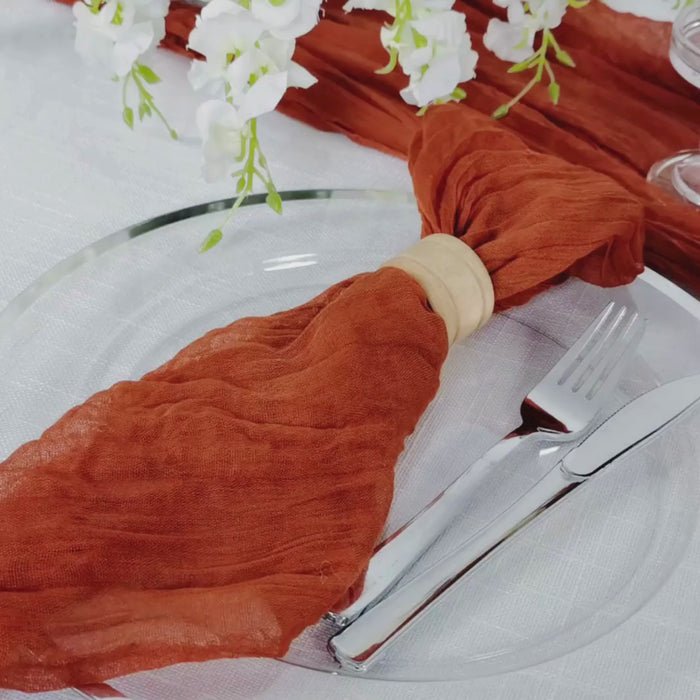 Terracotta reusable boho dinner napkins on a table setting.