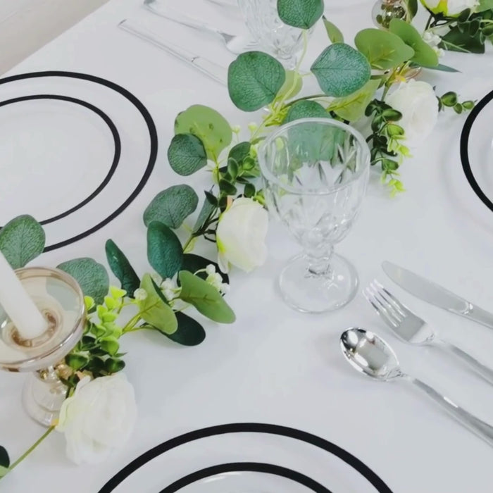 Clear plastic appetizer plates with black rim, elegant table setting.