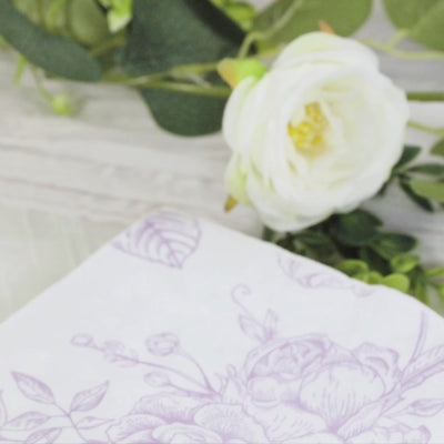 Matte lavender floral paper napkin on a soft background with greenery.