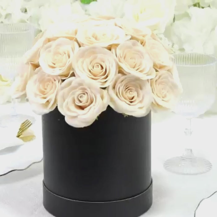 Ivory rose centerpiece arrangement in a black round gift box.