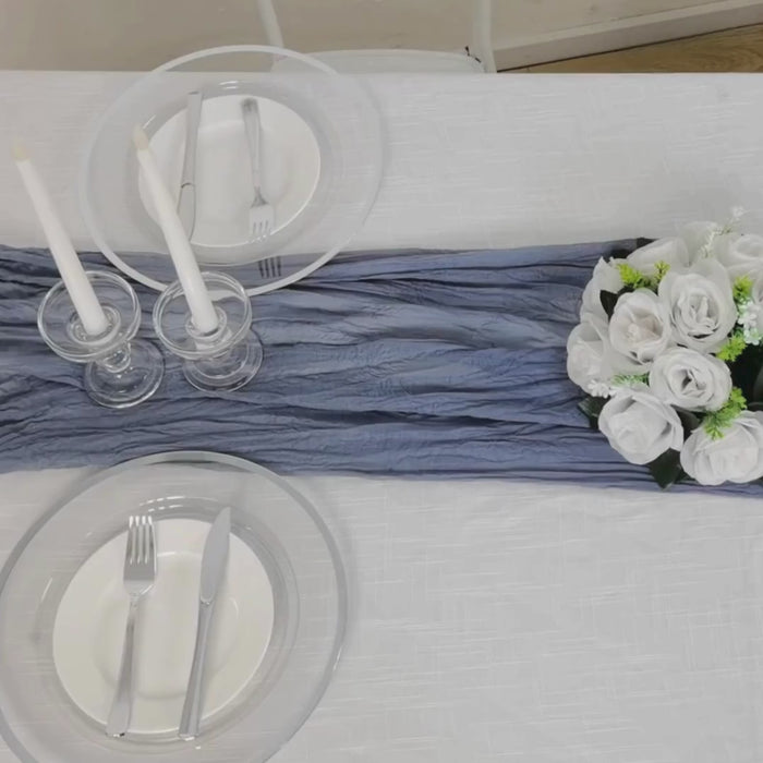 Dusty blue gauze cheesecloth table runner on a dining table.
