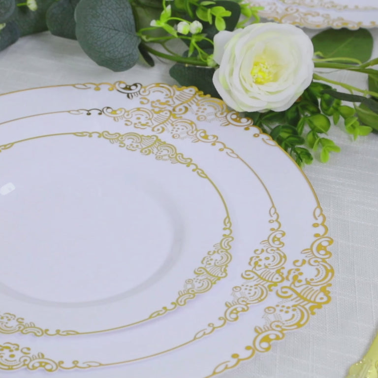 White charger plates with gold embossed baroque rim for elegant dining.