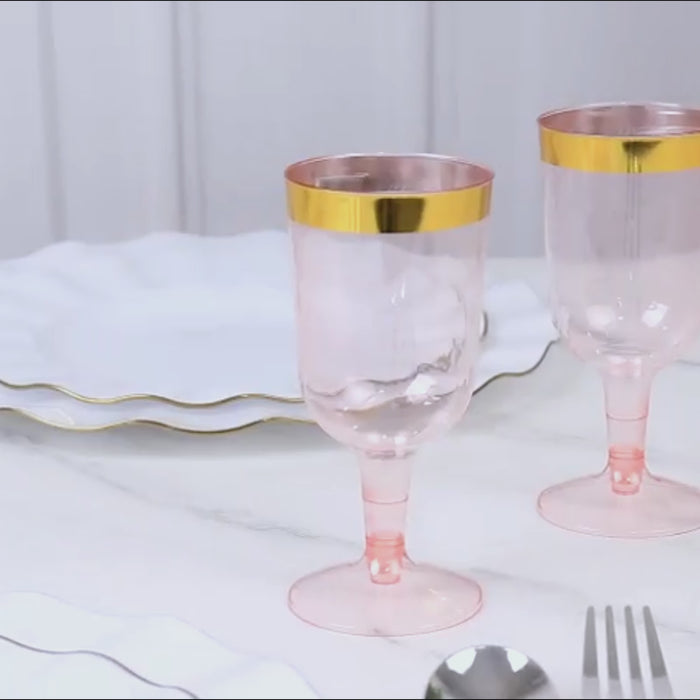 Transparent blush wine glasses with gold rim, perfect for parties.