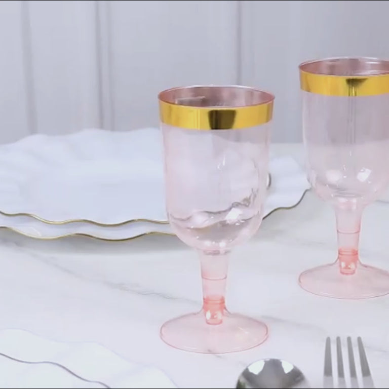 Transparent blush wine glasses with gold rim, perfect for parties.