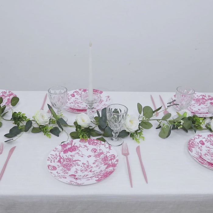 Pink & white floral disposable salad plates on a decorated table setting.