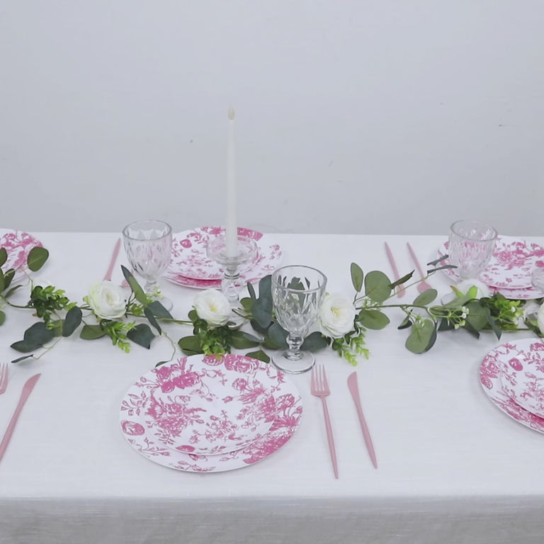 Pink & white floral disposable salad plates on a decorated table setting.