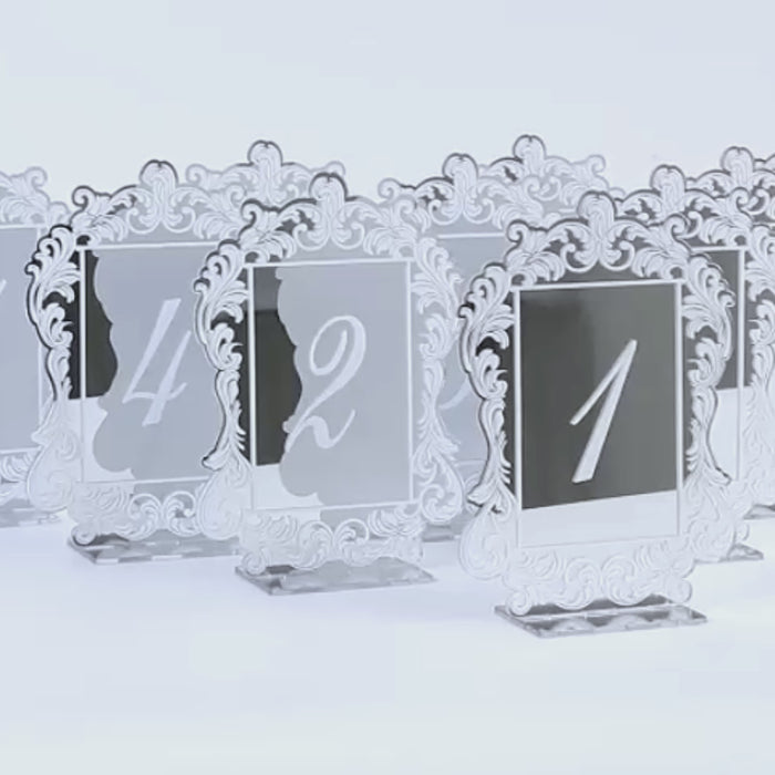 Silver mirror wedding table numbers with baroque lace border and white print.