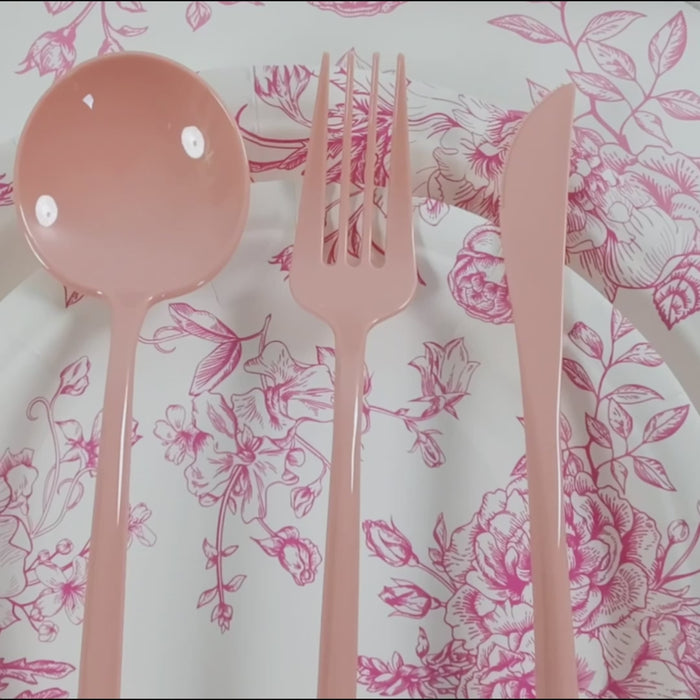 Dusty rose heavy-duty plastic utensils on a floral plate.