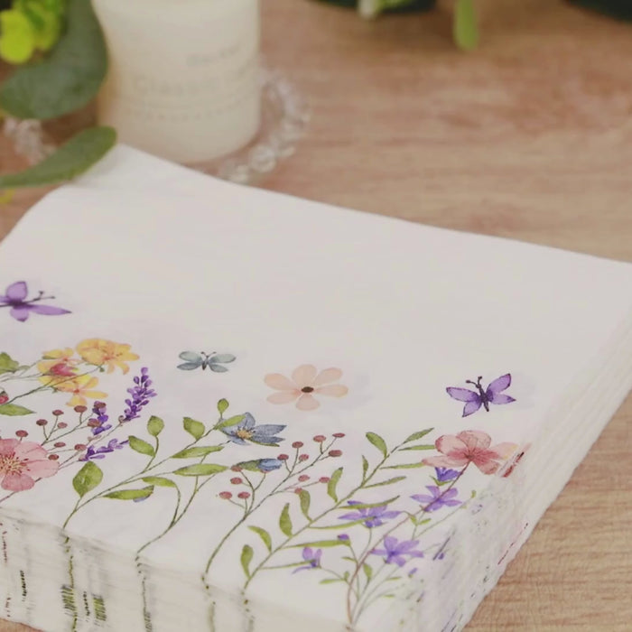 Wildflower butterfly design paper cocktail napkins in soft pastel colors.