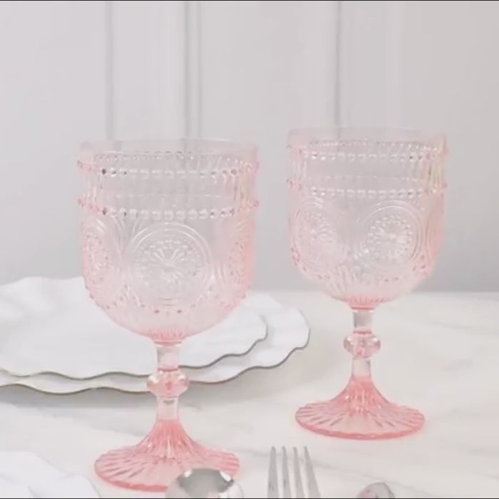 Blush vintage plastic wine goblets with embossed floral pattern.