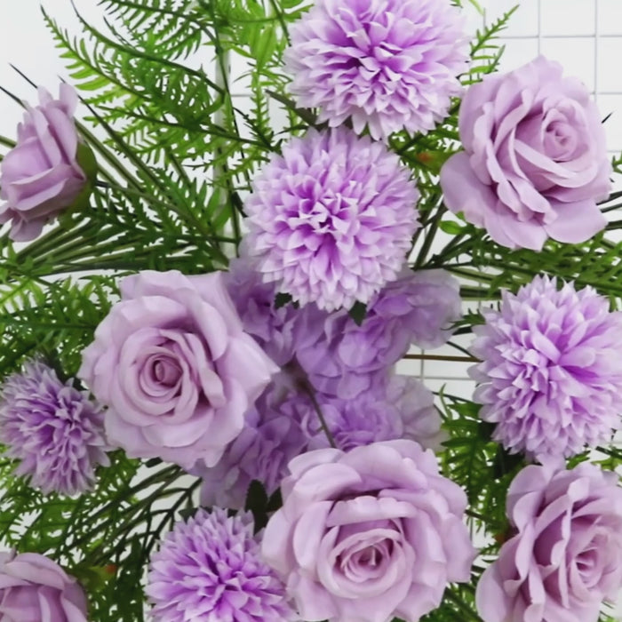 Lavender floral swag with roses and chrysanthemums adorned with greenery.
