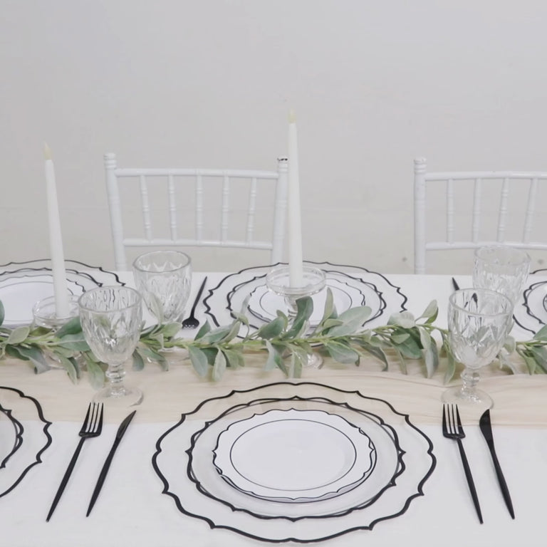 Clear plastic round dinner plates with black scalloped rims, perfect for parties.