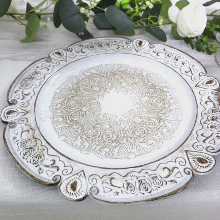 Antique white floral embossed charger plate with scalloped rim.