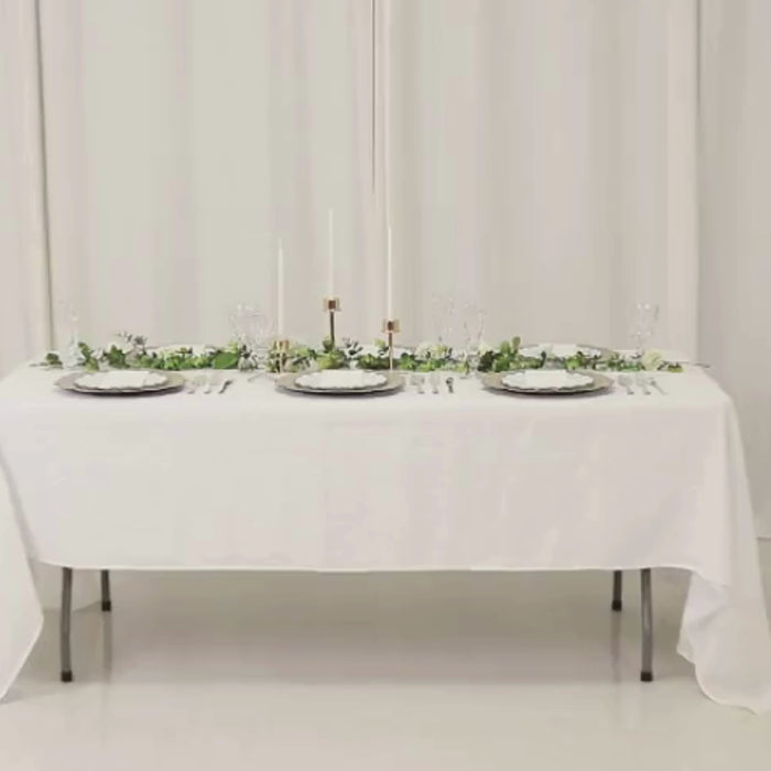 Taupe round charger plates with reef design on a white table setting.