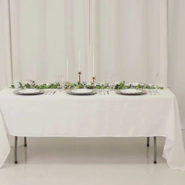 Taupe round charger plates with reef design on a white table setting.