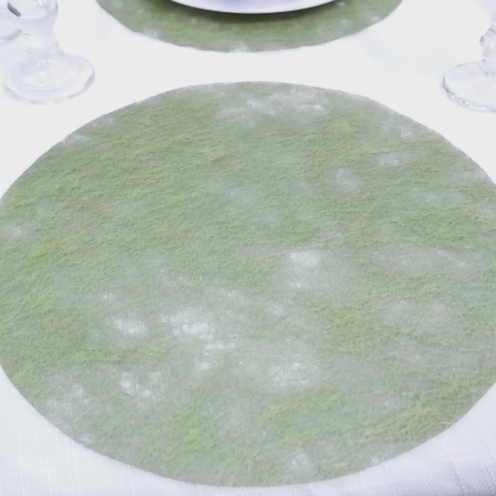 Olive green disposable round placemat on a dining table.