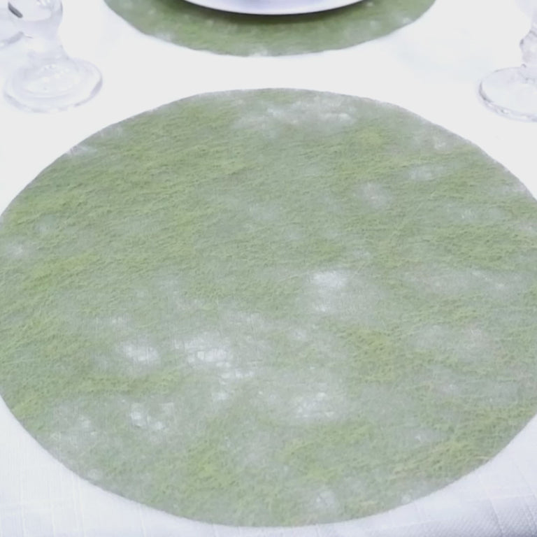 Olive green disposable round placemat on a dining table.