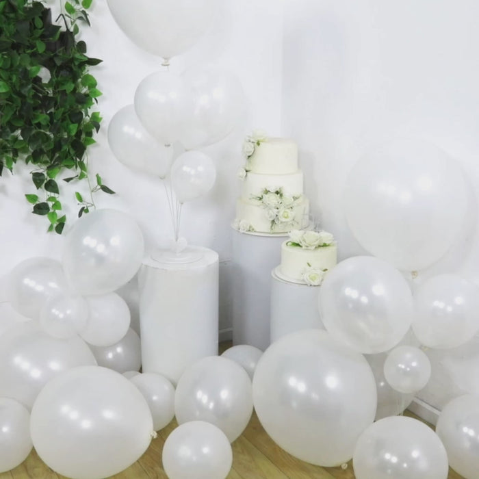 Pearl white biodegradable balloon arch kit displayed at a celebration.