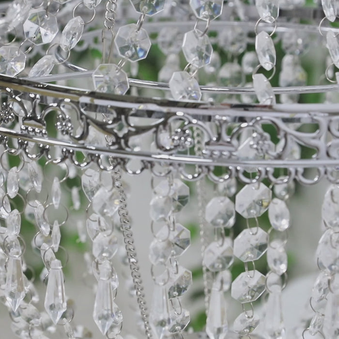 Silver beaded crystal chandelier with ornate metal frame.