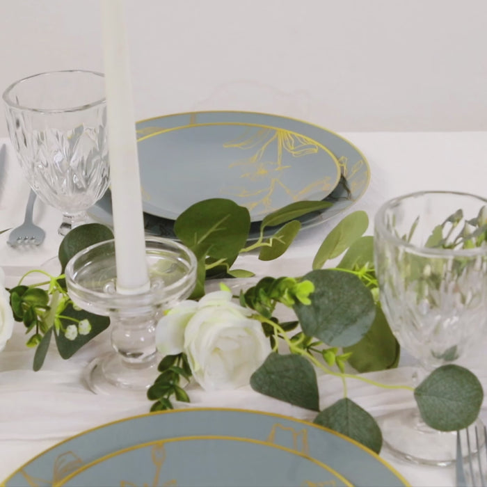 Dusty blue disposable plates with gold floral design set for parties.