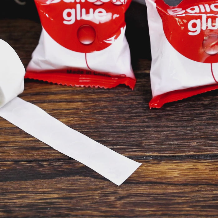 Clear balloon tape and glue dots for party decorations.