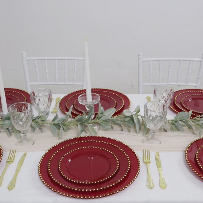 Red disposable dinner plates with gold beaded rim for elegant gatherings.