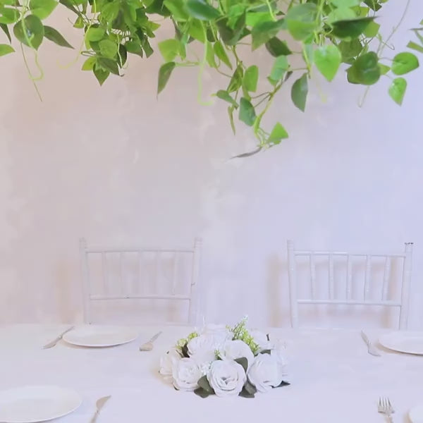 Green artificial ivy leaves chandelier with eucalyptus garland vines.