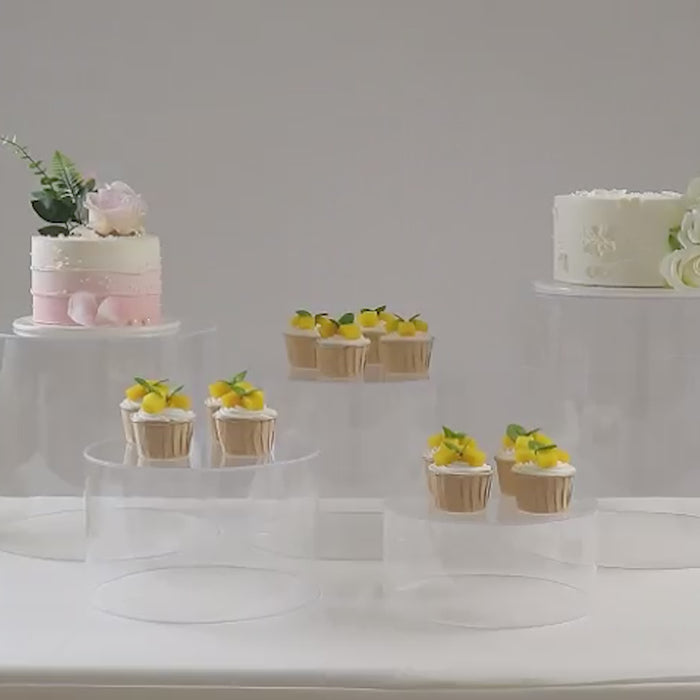 Clear acrylic cake stands in various sizes for wedding displays.