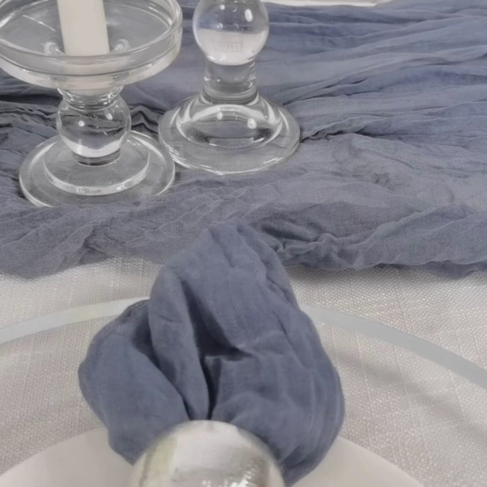 Dusty blue reusable gauze cheesecloth napkin on a table setting.