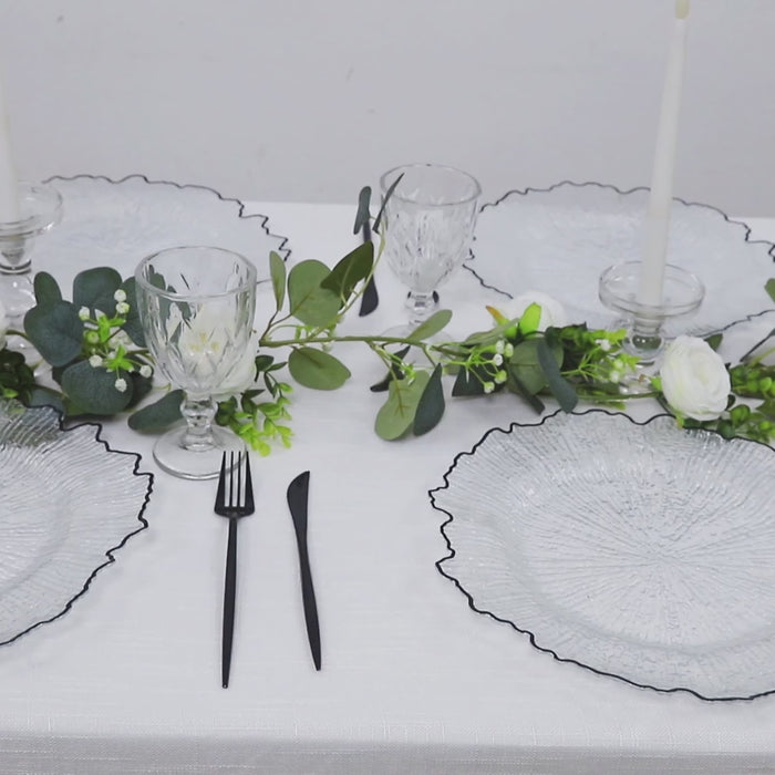 Clear round charger plates with black rim, decorative for dinner parties.