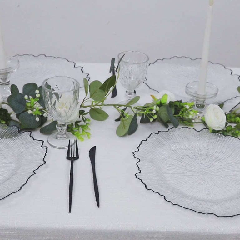 Clear round charger plates with black rim, decorative for dinner parties.