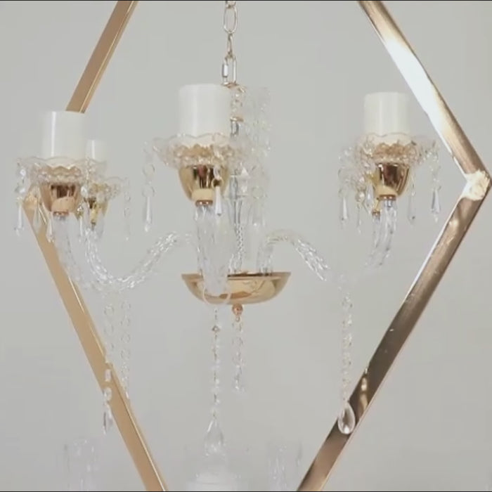 Gold acrylic candelabra centerpiece with candle holders.