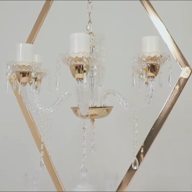 Gold acrylic candelabra centerpiece with candle holders.