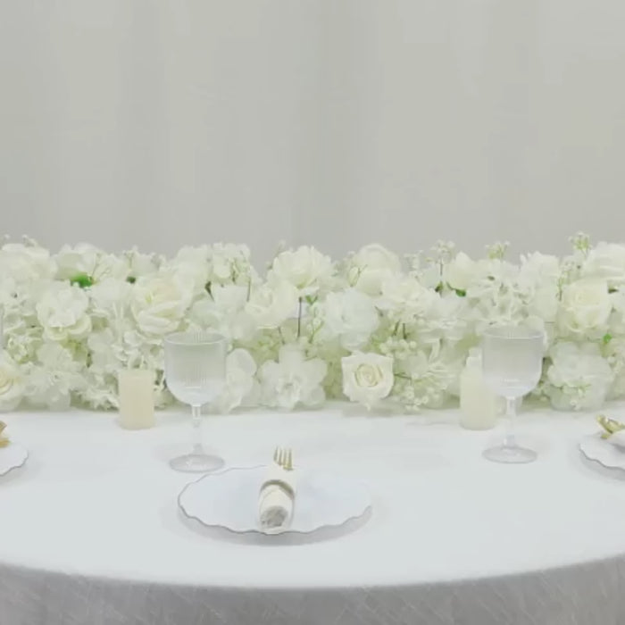 White floral runner with roses, hydrangeas, and baby's breath for wedding decor.