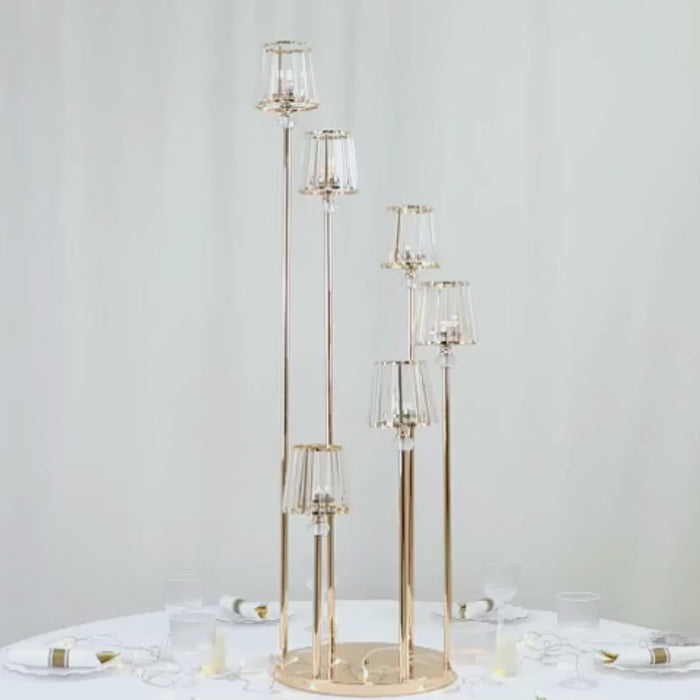 Gold crystal candelabra candle holder with six arms on a round base.