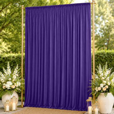 Purple draped backdrop with gold frame and floral wedding decor outdoors