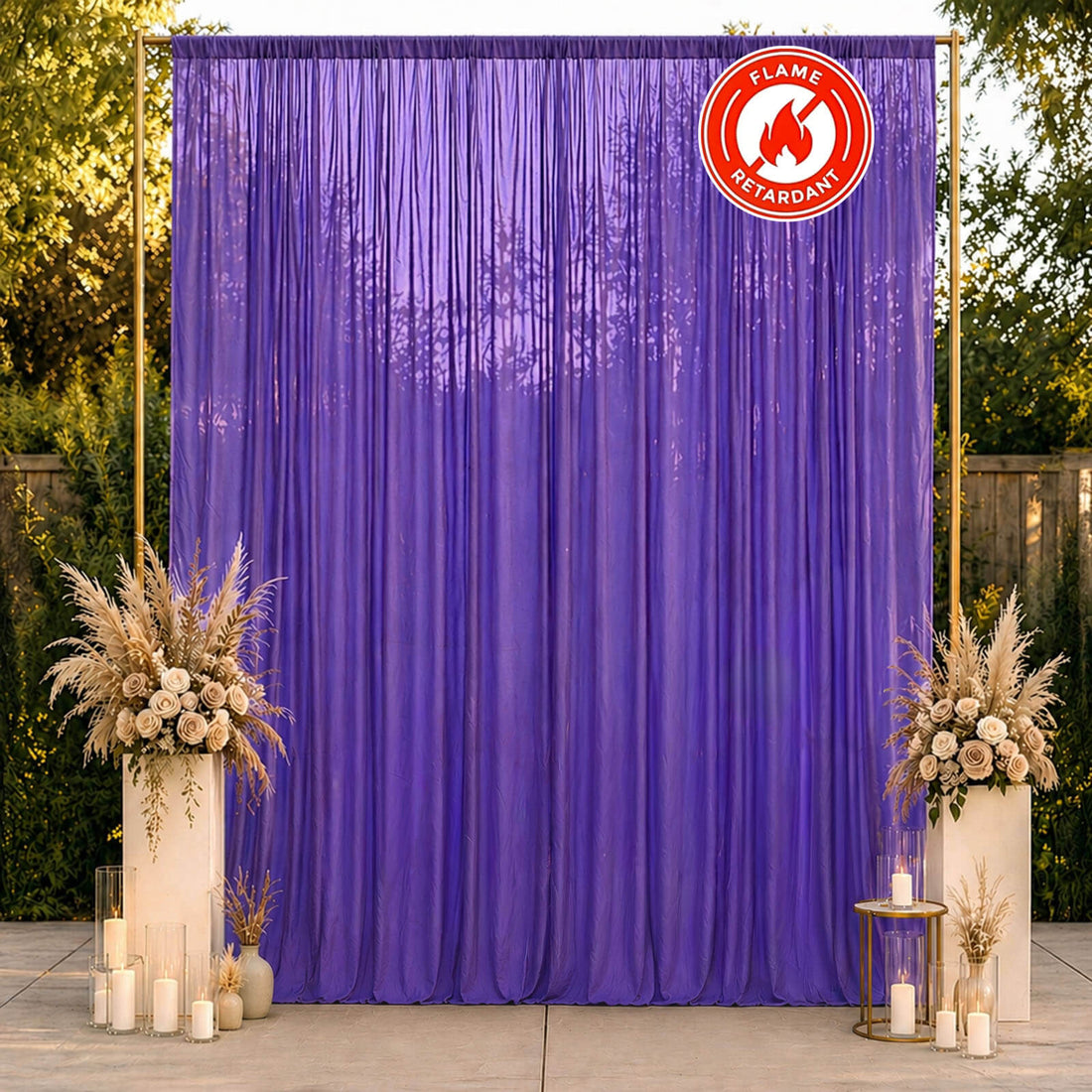 Purple flame retardant event backdrop with floral decor and candles