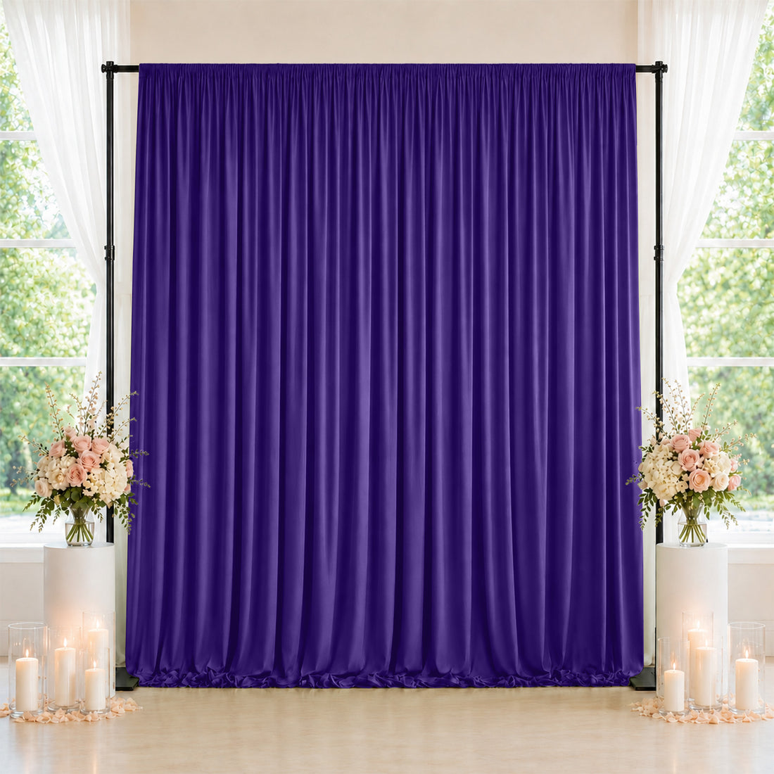 Purple wedding backdrop with floral arrangements and candles on elegant display