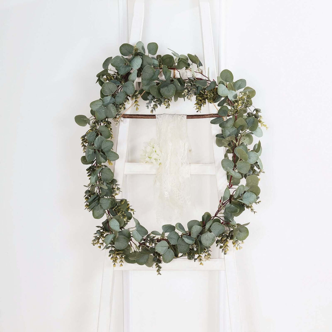 Eucalyptus wreath hanging on a white ladder