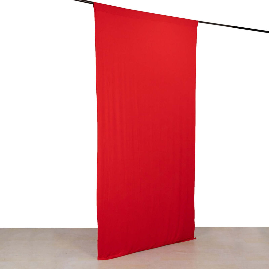 Red fabric backdrop draped on a rod for photography or staging purposes