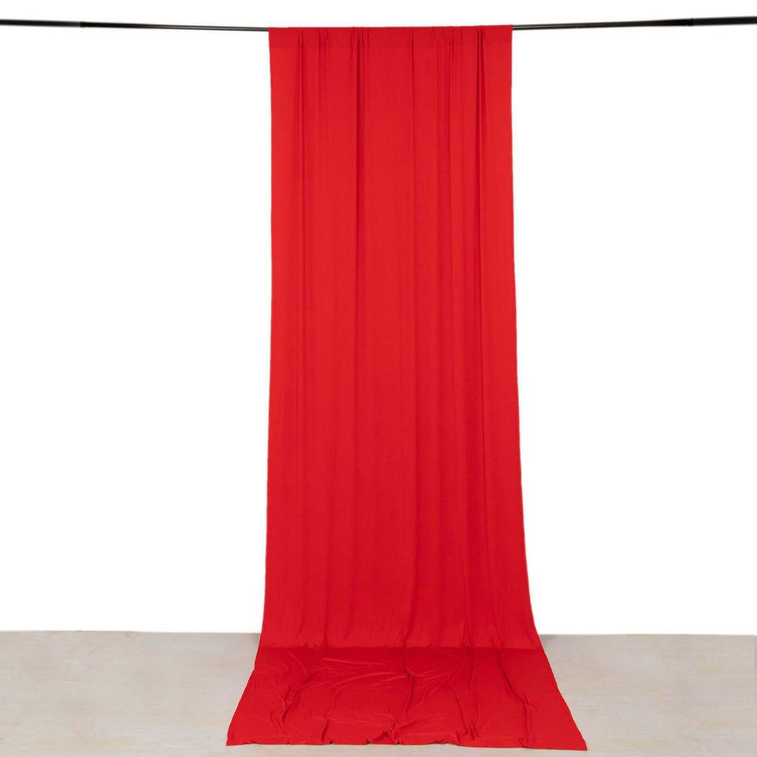 Red fabric backdrop draped smoothly for photography use.