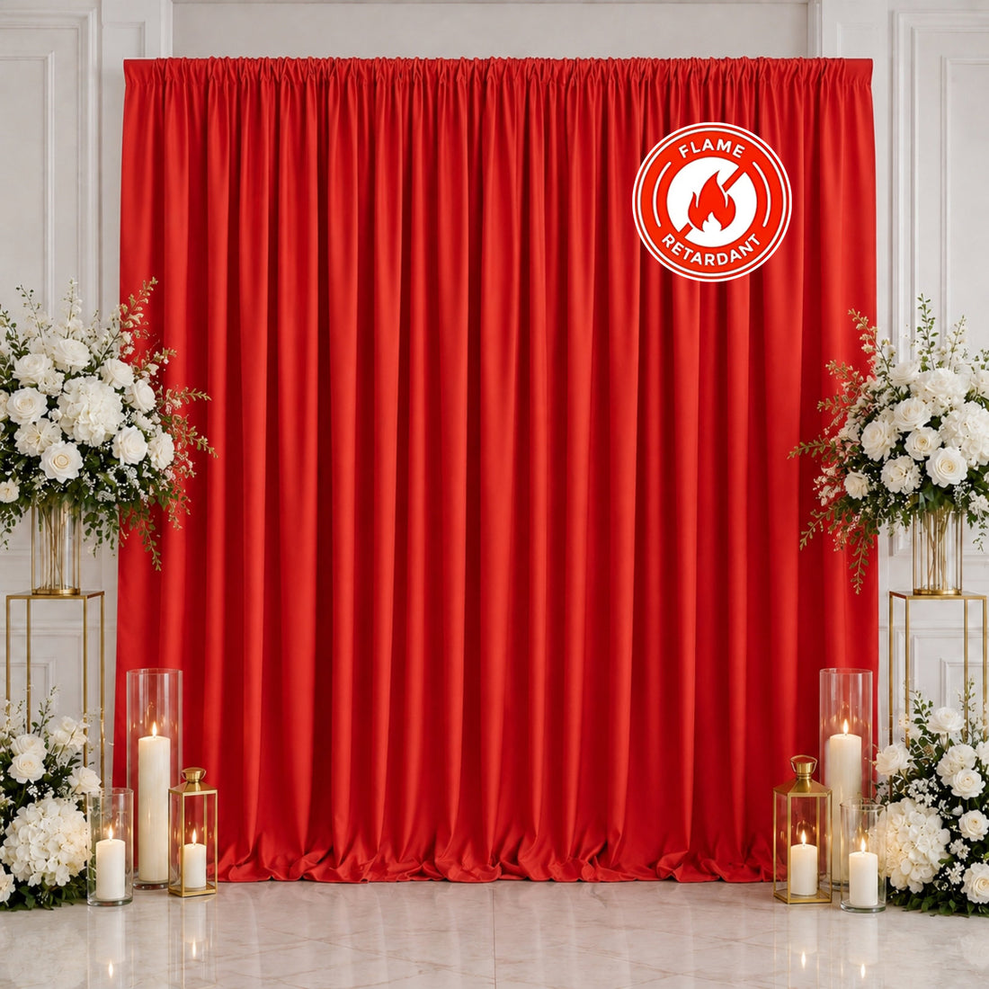 Red flame retardant curtain backdrop with white floral arrangements and candles