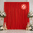 Red flame retardant curtain backdrop with white floral arrangements and candles
