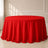 Red polyester round tablecloth with a seamless finish.