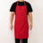 Red kitchen apron worn by a person against a plain background